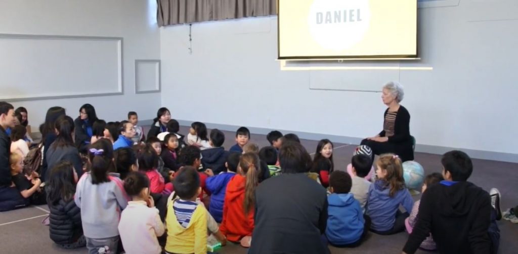 children  sitting and listening to a story